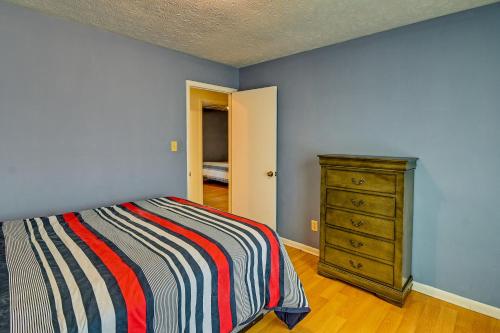 a bedroom with a bed and a dresser at Fayetteville Vacation Rental with Yard! in Fort Bragg