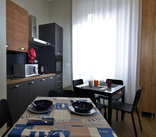 a kitchen and dining room with a table and chairs at VIVI A NAPOLI in Naples