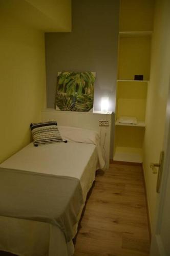 a small bedroom with a bed in a room at Apartamentospedroche Sitges in Sitges