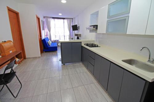 a kitchen with a sink and a counter top at Apartahotel La Villa Santa fe de Antioquia in Santa Fe de Antioquia