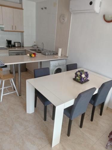 a kitchen with a white table and chairs at VANCOUVER en SALOU in Salou