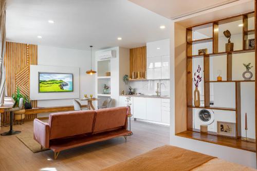 a living room with a couch and a kitchen at Coimbra Premium Downtown in Coimbra