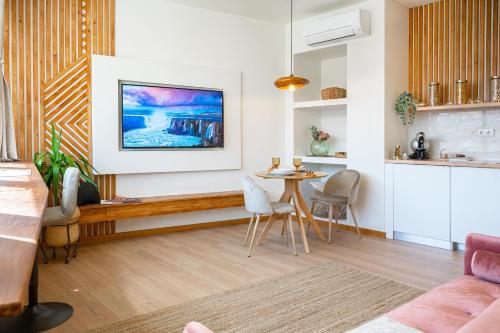 a living room with a table and chairs at Coimbra Premium Downtown in Coimbra