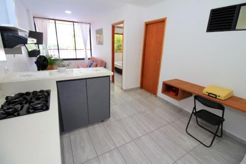 a kitchen with a stove and a counter top at Apartahotel La Villa Santa fe de Antioquia in Santa Fe de Antioquia