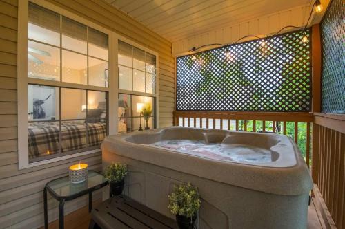 a jacuzzi tub in a porch with a window at Great Smoky Mountain Get-Away in Pigeon Forge
