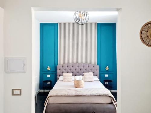 a bedroom with blue and white walls and a bed at Lena's Suites Bari Vecchia in Bari