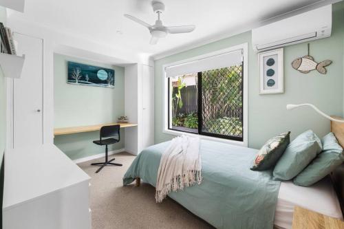 a bedroom with a bed and a window and a desk at The Sunrise Cubby House in Sunrise Beach