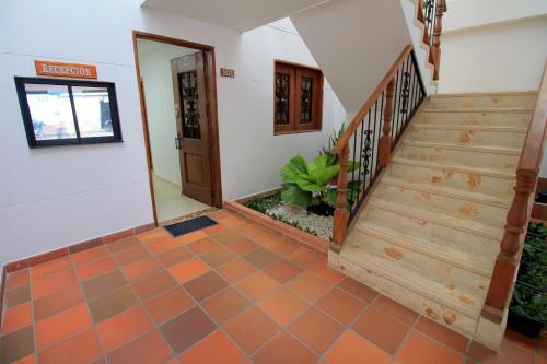 a staircase in a house with an orange tiled floor at Apartahotel La Villa Santa fe de Antioquia in Santa Fe de Antioquia