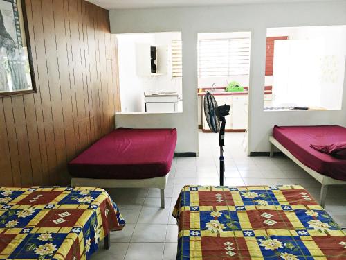 a room with two beds and a kitchen at African Symbol Guest House in Montego Bay