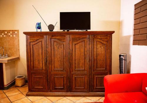 a large wooden cabinet with a television on top of it at Hotel Casa Pereyra in Oaxaca City