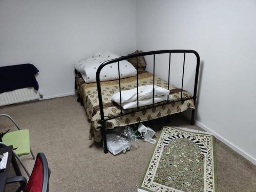 a small bed in a room with a mirror at Room for rent in Aberdeen