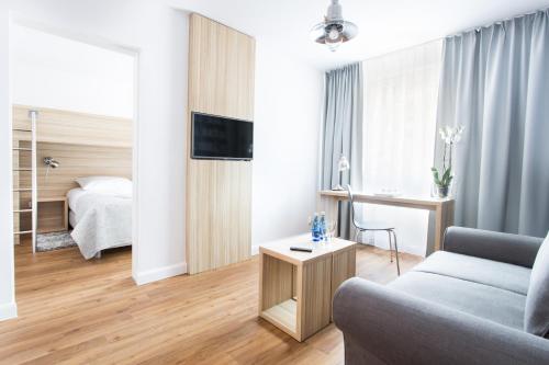 a living room with a couch and a bed at Smart Hotel in Gdańsk