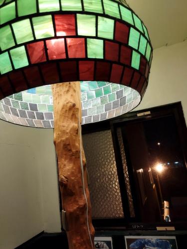 a stained glass lamp hanging from a wall at Takamatsu Guesthouse BJ Station in Takamatsu