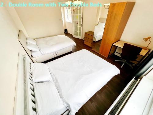 a small room with two beds and a desk at Central Palace - Excellent Stay in London Zone 1 in London