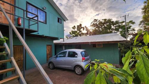a small car parked in front of a house at Cabañas Manuto in Hanga Roa