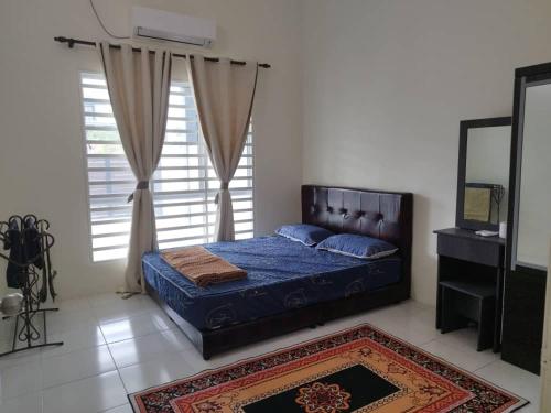 a bedroom with a bed and a large window at Homestay Delisha Tapah-Pool in Tapah