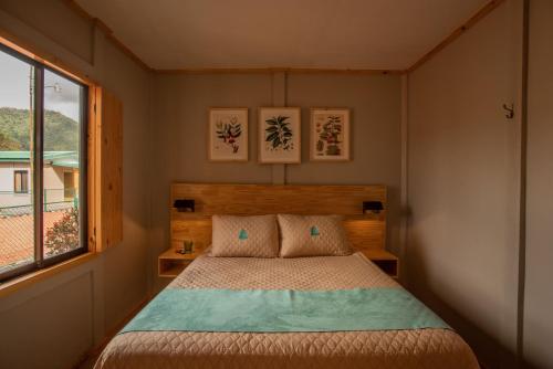 a bedroom with a bed and a window at Coffee Pickers Village By Hacienda Orosi in Cartago
