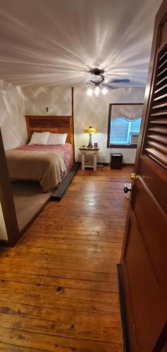a bedroom with a bed and a ceiling at Hootie Creek Guest House in Talihina