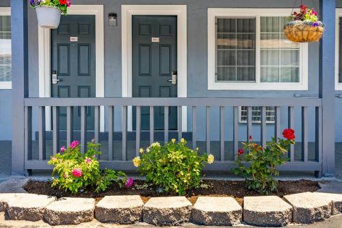 a blue house with flowers in front of it at The Monterey Fireplace Inn in Monterey