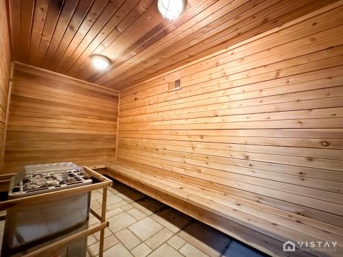 a sauna with a wooden wall and a stove at Luxury Ski Condo With Hot Tub in Brian Head