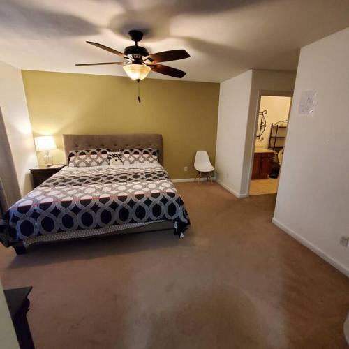 a bedroom with a bed and a ceiling fan at Amazing palm villa house in Riverside