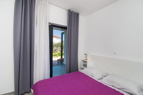 Postel nebo postele na pokoji v ubytování Apartments Slavica