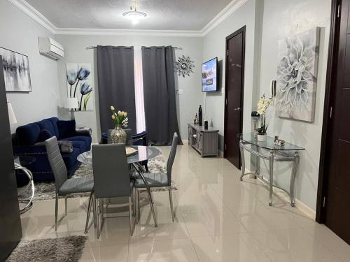 un salon avec une table et un canapé bleu dans l'établissement Entire Apartment with Pool near AC Marriott Hotel in Kingston, à Kingston