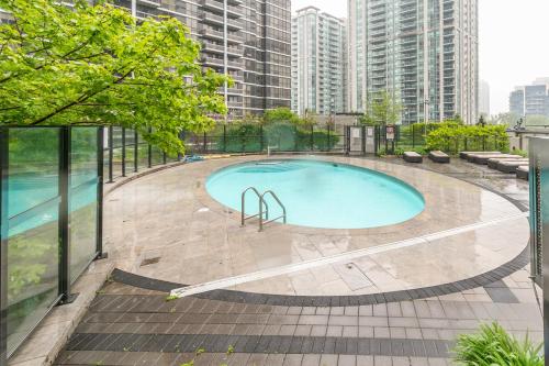 a swimming pool on top of a building with tall buildings at GLOBALSTAY Modern Apartments in North York Skyscraper in Toronto