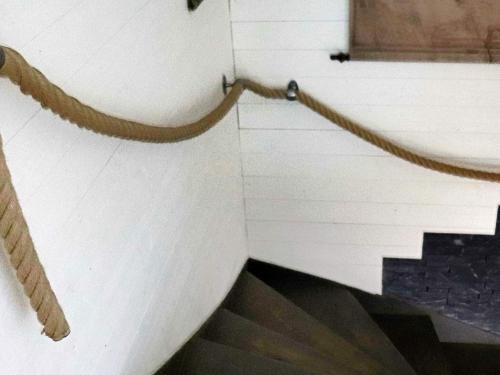a stairway with a rope attached to a white wall at 5 person holiday home in Halmstad-By Traum in Halmstad