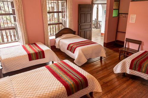 a room with four beds in a room at Casona Del Rosario - Plaza de Armas in Chachapoyas