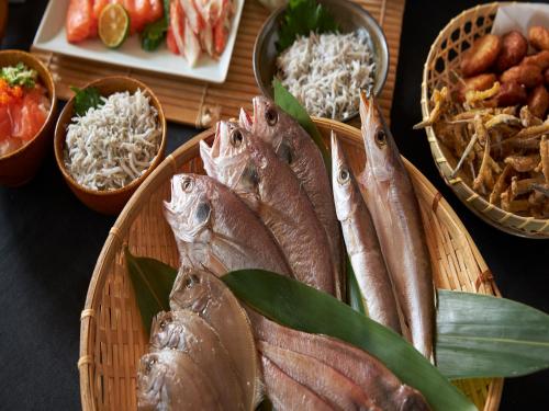 a bunch of fish in baskets on a table at REF Kansai Airport by VESSEL HOTELS in Izumi-Sano