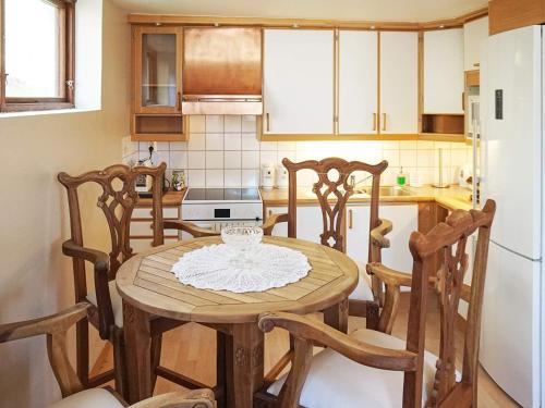 a kitchen with a wooden table and four chairs at 4 person holiday home in HÄLLEVADSHOLM-By Traum in Hällevadsholm