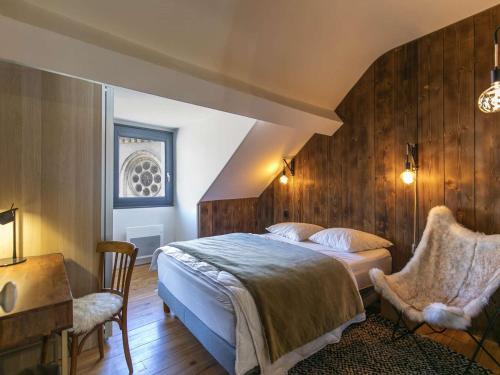 a bedroom with a bed and a table and chairs at Maison Cauterets, 7 pièces, 8 personnes - FR-1-401-260 in Cauterets