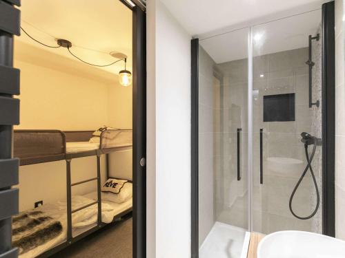 a bathroom with a shower and a glass door at Maison Cauterets, 7 pièces, 8 personnes - FR-1-401-260 in Cauterets