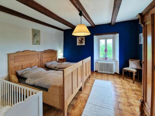 a bedroom with a bed and a blue wall at Belvilla by OYO Villa Due Pini Cavallino in Montecosaro
