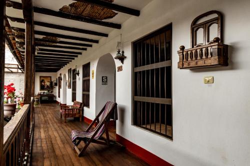 a hallway of a house with a chair on a porch at Casona Del Rosario - Plaza de Armas in Chachapoyas