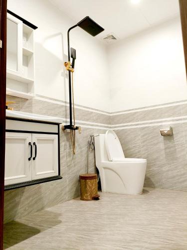a bathroom with a white toilet in a room at Villa FLC Sam Son Lavender in Sầm Sơn