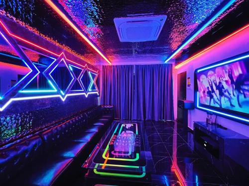 a party room with a dj console and neon lights at Dato Villa Luxury Homestay 12min to Jonker Street 26pax Private Pool Playground KTV BBQ in Melaka