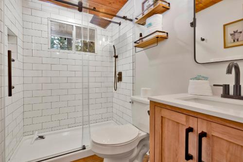 a bathroom with a toilet and a sink at The Lost Compass- Hot Tub- Games- Walk To Lake or Marina in Big Bear Lake