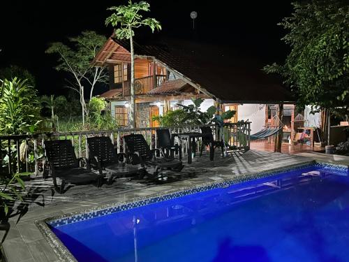 a house with a swimming pool at night at QUINTA VACACIONAL DIEGO ALFONSO, MY house in Macas in Macas
