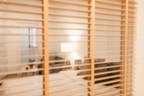 a room with a window with wooden blinds at Hotel PAPA Bangkok in Bangkok