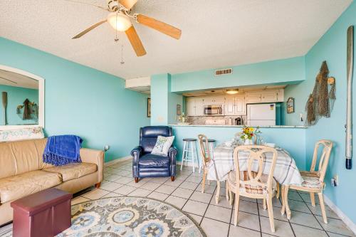 a living room with a couch and a table at Bright Carolina Beach Condo Public Beach On-Site in Carolina Beach