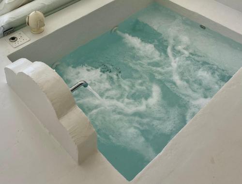 a bath tub with a view of the water at MAREULIVI in Ostuni