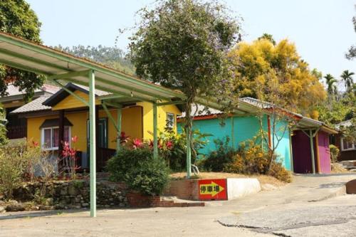a house is painted yellow and blue at Xiangcun Homestay in Gukeng