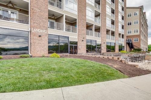 a large building with a lawn in front of it at Lakefront Huddleston Condo with Community Pool in Huddleston
