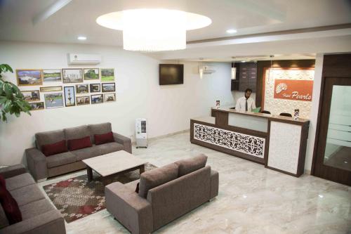 a lobby with a person standing at a counter at Hotel Pearls in Aurangabad