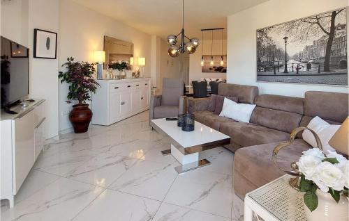 a living room with a couch and a table at Cozy Apartment In Mijas With Swimming Pool in Mijas