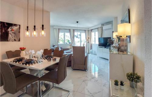 a dining room and kitchen with a table and chairs at Cozy Apartment In Mijas With Swimming Pool in Mijas