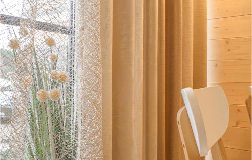 a room with a window with a curtain at Awesome Home In Wilcze With Sauna in Wilcze