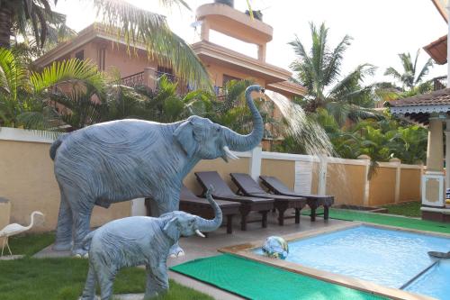 a statue of an elephant standing next to a swimming pool at Villa Calangute Phase 5 in Calangute